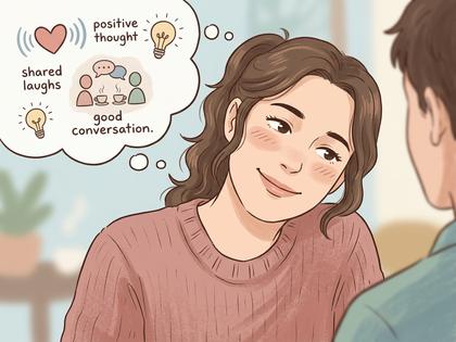 オフィスで同僚と話す女性、体ごと相手の方を向いて笑っている様子